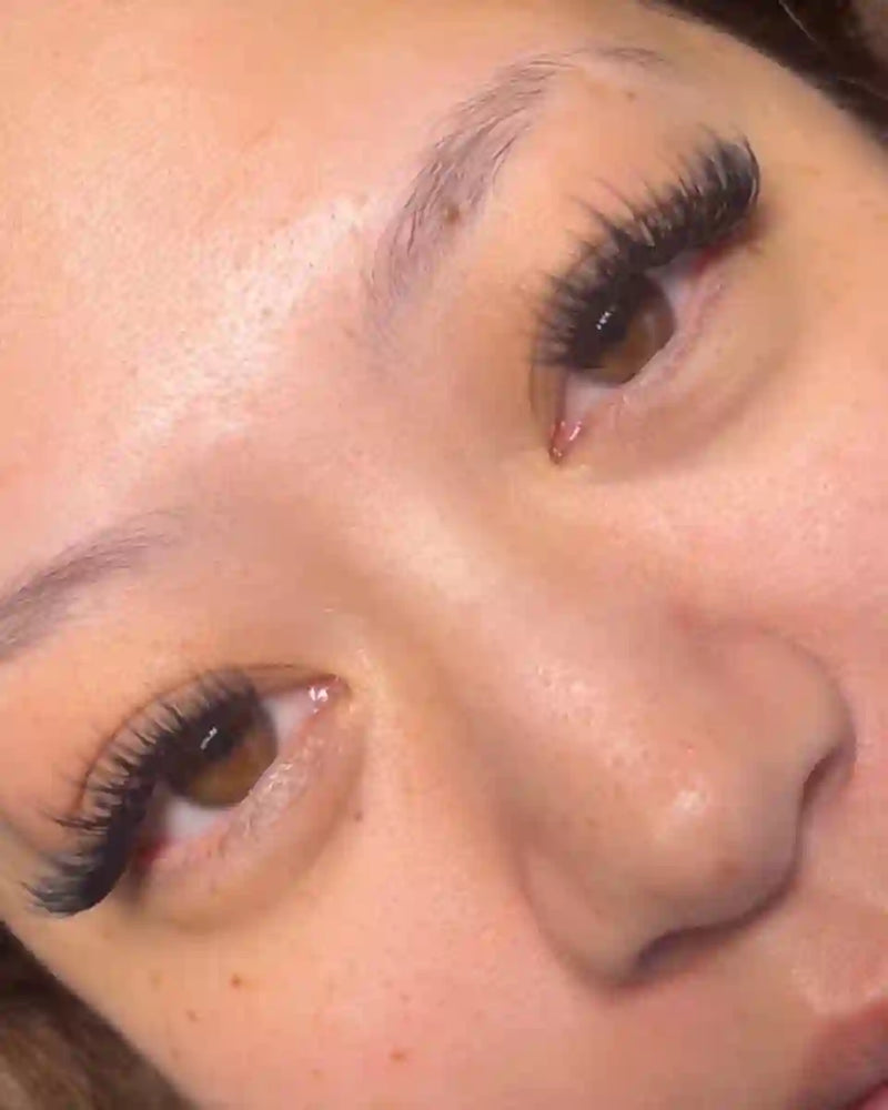 A beautiful woman looking straight into the camera, showcasing her false
