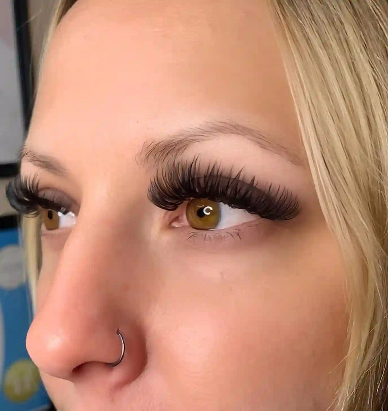 A beautiful woman posing in side view to showcase her false eyelashes