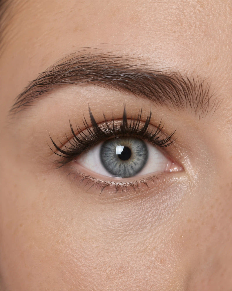 Wispy StarlitTip lashes resting on a white surface