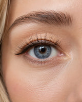 Close-up of eye with dark false lashes on upper lid