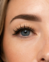 Close-up eye with magnetic false lashes, thick curled dark lashes
