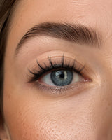 Close-up of eye wearing dark curled false lashes along the lash line