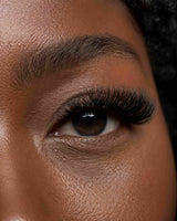Close-up of one eye featuring thick eyelash extensions and defined lash line