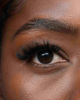Close-up eye wearing long dark eyelash extensions along the lash line