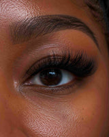 Handmade lash extensions on a woman's eye, showing long, curved lashes