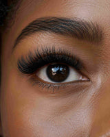 Close-up of eye with matte black clustered lashes, adding length and volume