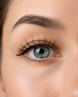 Magnetic false lashes close-up, long black lashes on blue eye