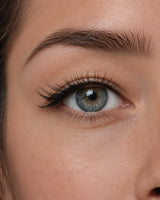 False eyelashes on an eye close-up with long lashes along the upper lash line.
